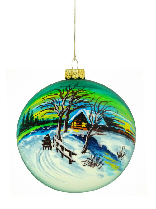 A glass Christmas tree ornament with a hand-painted winter landscape