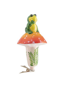A glass Christmas bauble in the shape of a frog on a mushroom