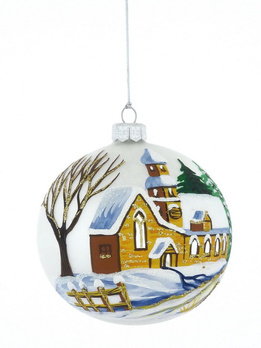 A glass Christmas tree bauble with a painted winter landscape with a church