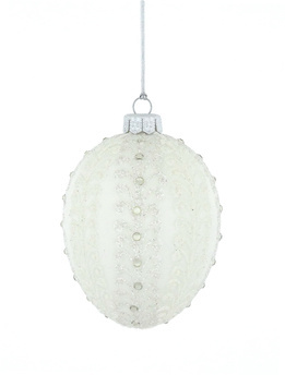 A glass Christmas tree bauble in the shape of a Faberge egg in white