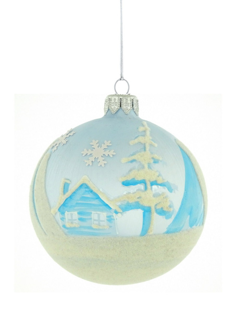 A glass Christmas tree ornament with a hand-painted winter landscape
