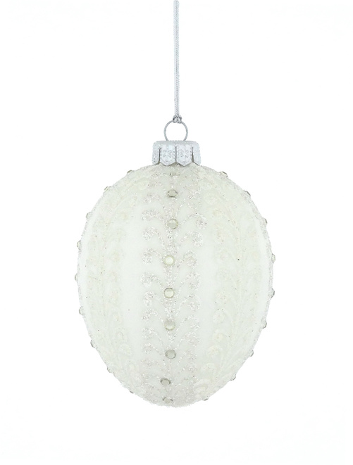 A glass Christmas tree bauble in the shape of a Faberge egg in white
