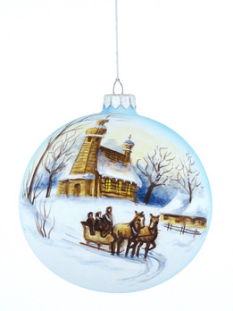 A glass Christmas tree bauble with a painted winter landscape with a winter sled motif