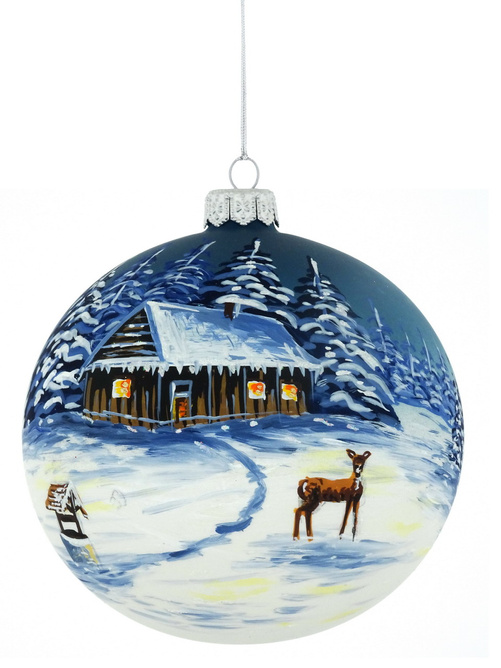 A glass Christmas tree ornament with a hand-painted winter landscape
